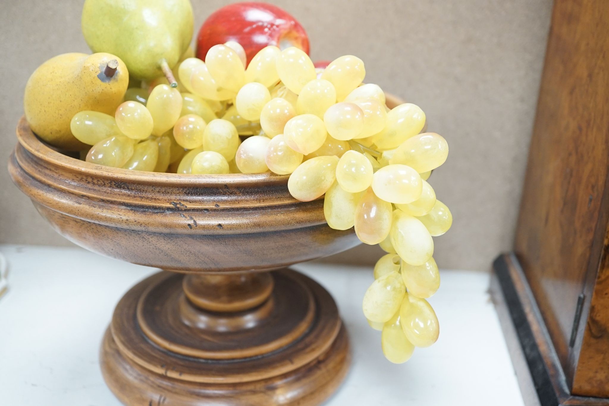 Faux fruit on a turned wood pedestal bowl